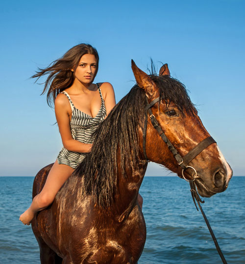 Girl riding horse on vacation