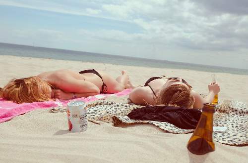 Two girls laying on beach