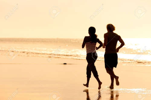 Couple jogging on beach to improve sex life